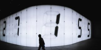 photo of man walking near LED signage