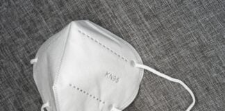 white leather sling bag on brown textile