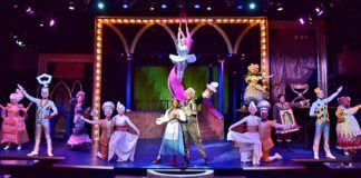 The enchanted castle characters invite Belle (Jameelah Leaundra) to "Be Our Guest" in Beef & Boards Dinner Theatre's production of Disney's "Beauty and the Beast."