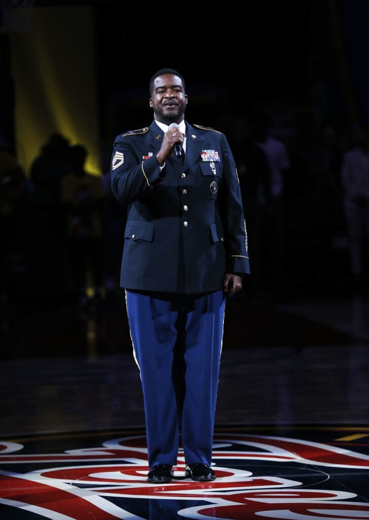 A photo of a member of United States Armed Services delivering the National Anthem before the Indiana Fever - Chicago Sky game at Gainbridge Fieldhouse on July 2.