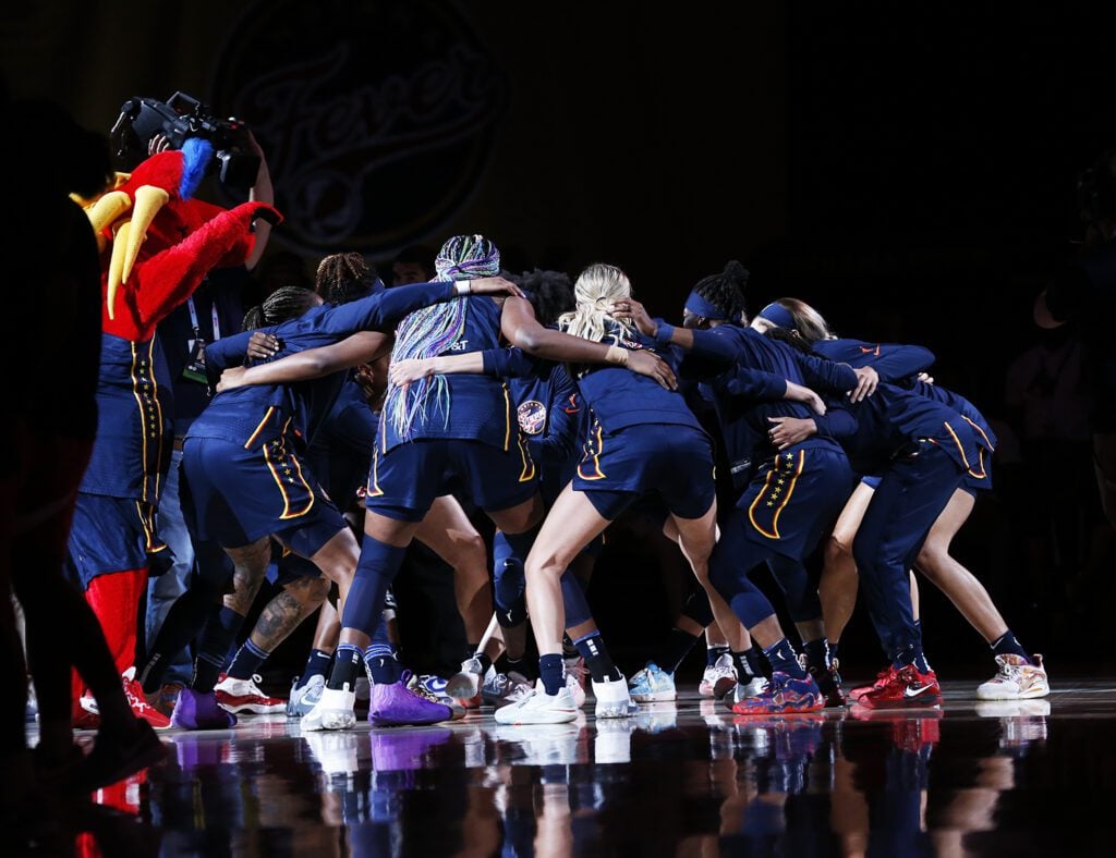 A photo of the Indiana Fever getting rowdy during the pregame with mascot Freddie Fever against the Chicago Sky on July 2 at Gainbridge Fieldhouse.