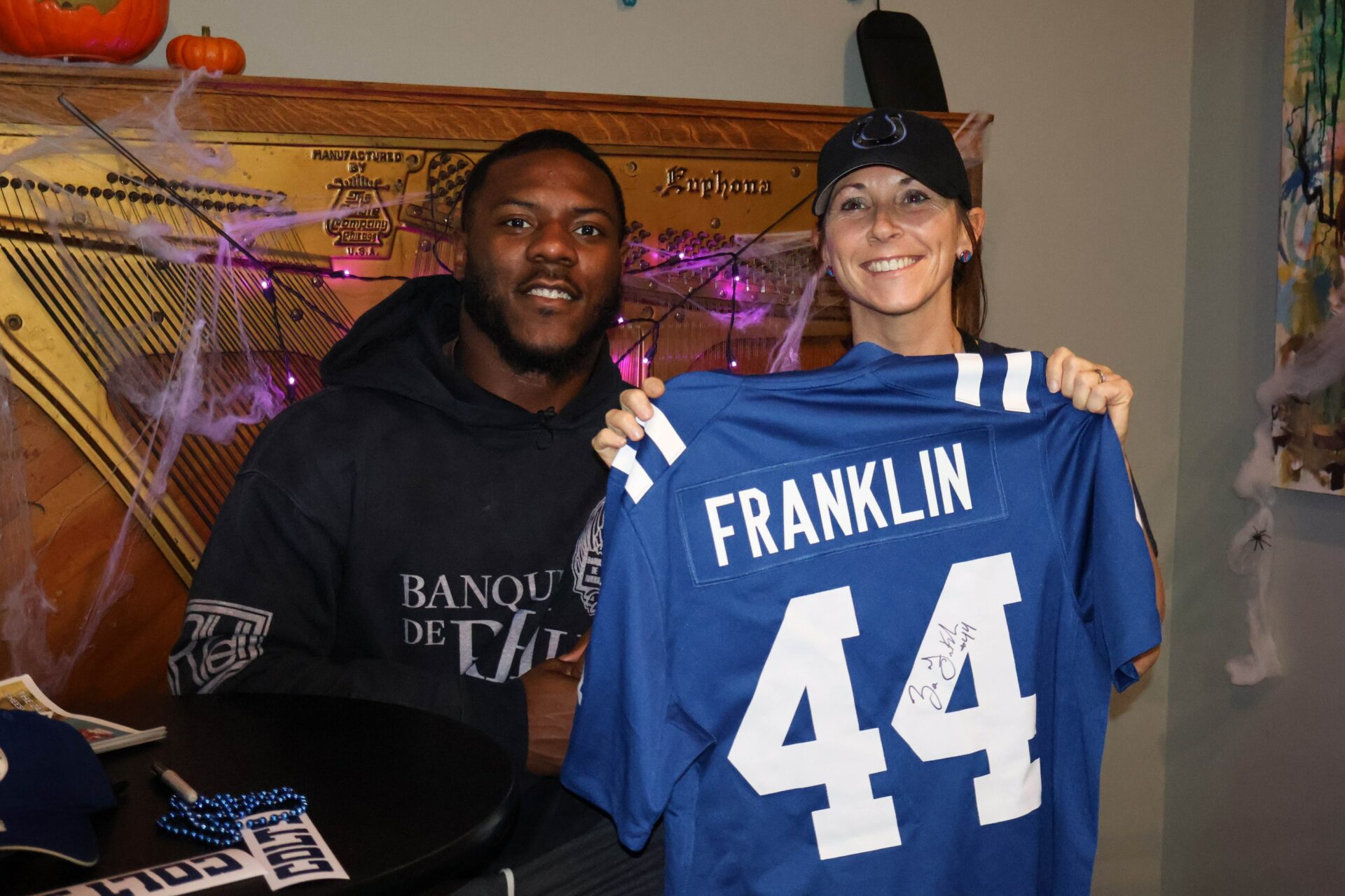 sports and philanthropy. Colts player during charity event at Hoagies and Hops with a fan.