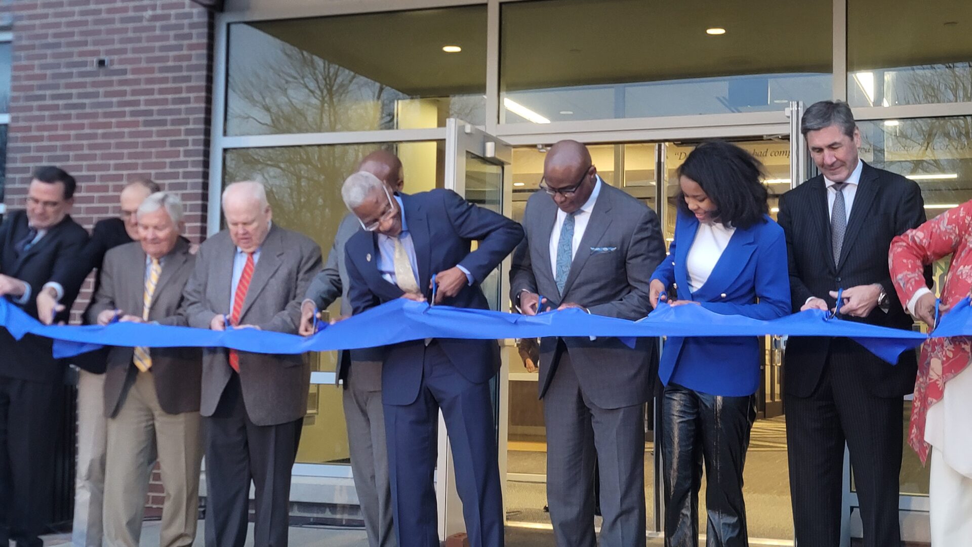 CLD ribbon cutting. people cutting a ribbon at the Center for Leadership Development