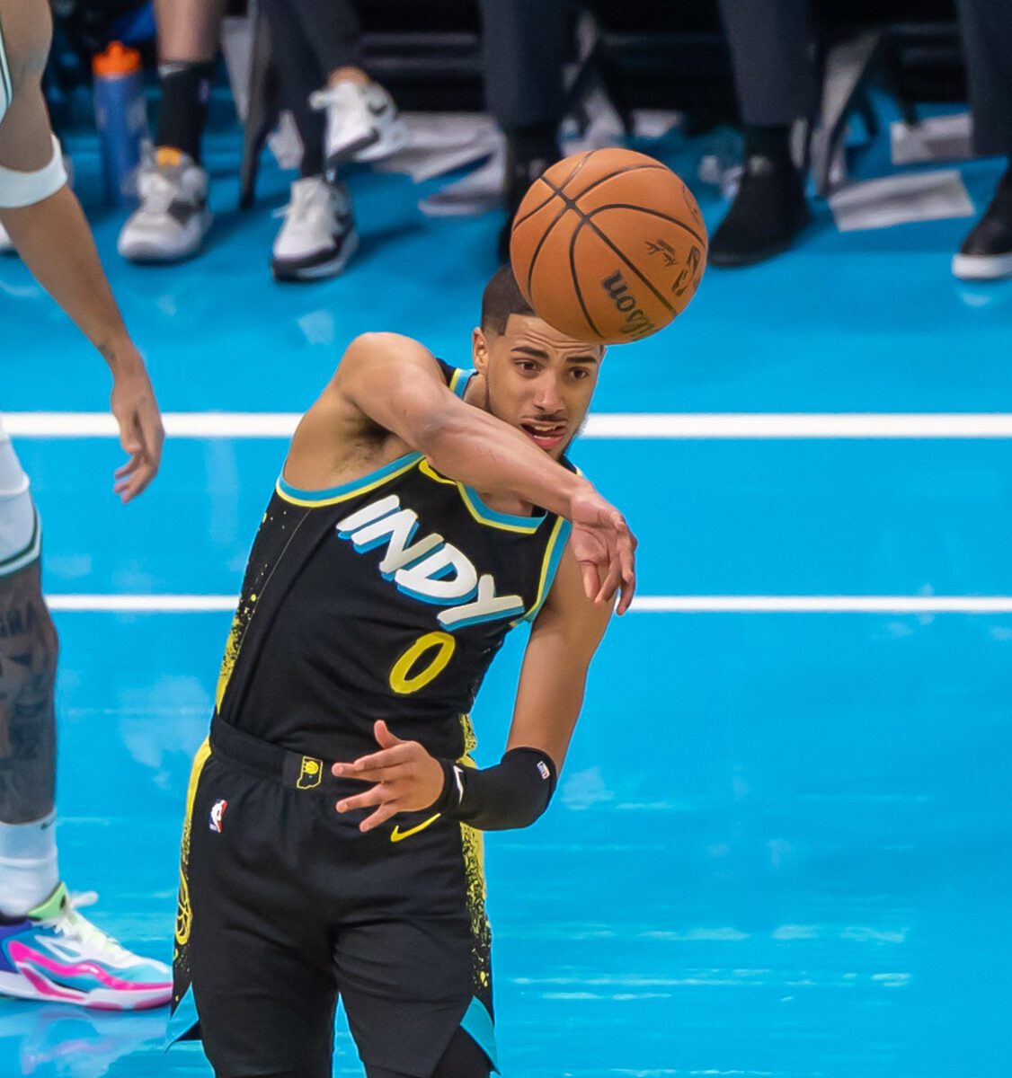 basketball player throwing flashy pass (assist) during NBA in-season tournament game.