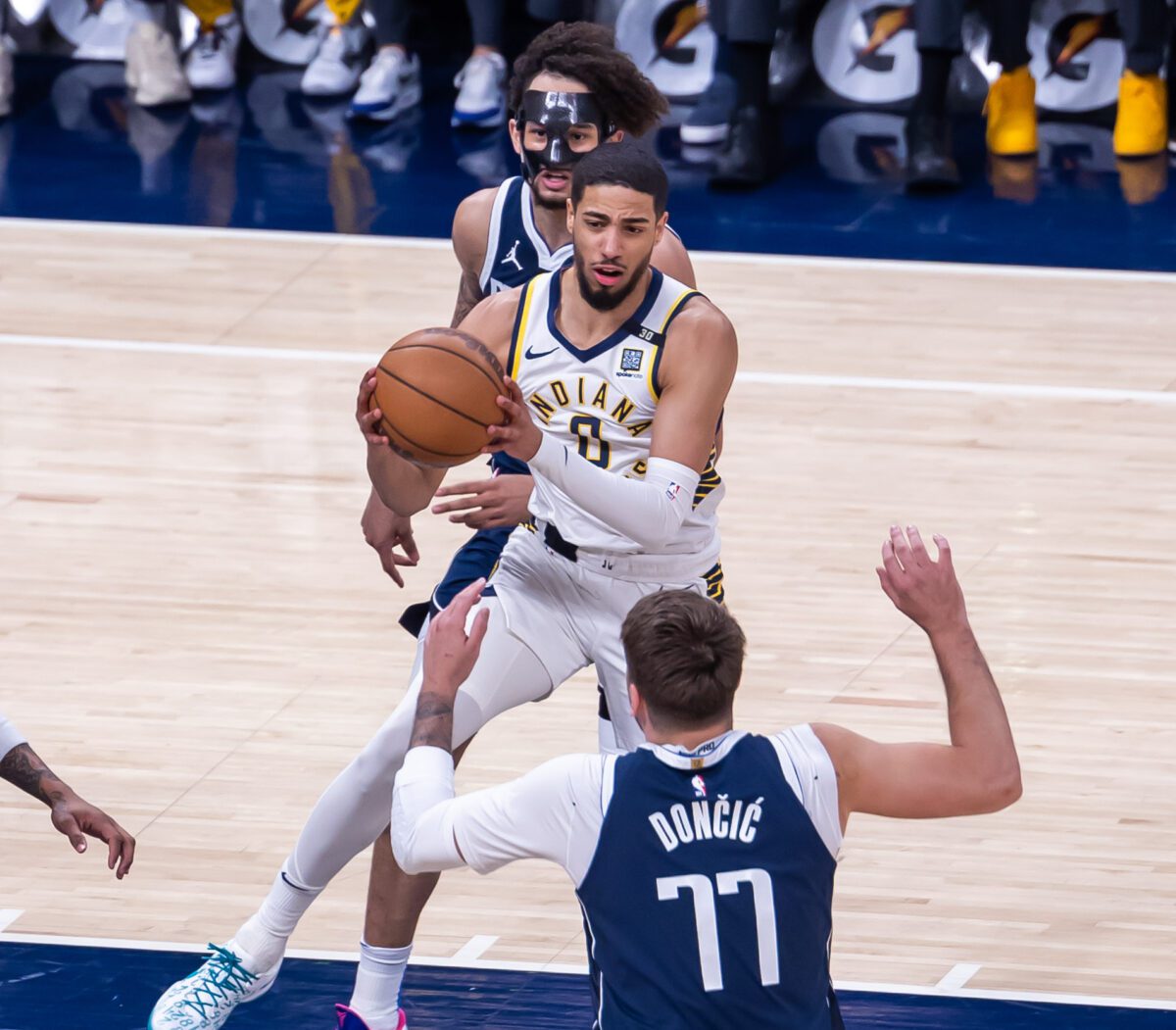 Indiana Pacers point guard Tyrese Haliburton (0) in the lane between Mavericks forwards Luka Doncic (77) and Derrick Lively II during their matchup at Gainbridge Fieldhouse, located in Downtown Indianapolis, IN., on February 25, 2024. (Photo/Walt Thomas)