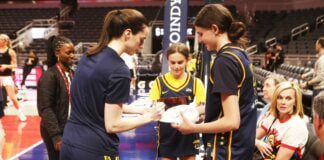 Caitlin Clark (left) and Grace Berger (right) sign autographs for a young fan prior to the start of the game against the Seattle Storm on May 30, 2024 at Gainbridge Fieldhouse in downtown Indianapolis, IN. (Photo/David Dixon)