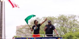 Tamika Catching waving the green flag during the 2024 500 Festival Parade in Indianapolis.