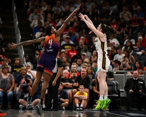 WNBA Player shooting a three-pointer.