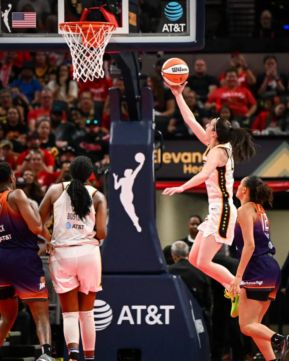 WNBA player shooting a layup.