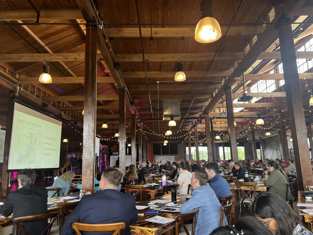 People gathered at tables to watch presentations