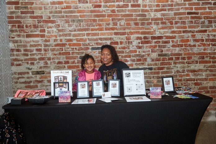 booth pic4 KaMara “KK” White, licensed therapist and children’s book author, promoting her work “Brown Girls Can” with her daughter Laila. (Photo provided/KaMara White)