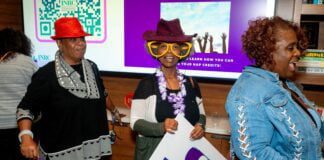 Three women dressed up for INRC's annual Jubilee