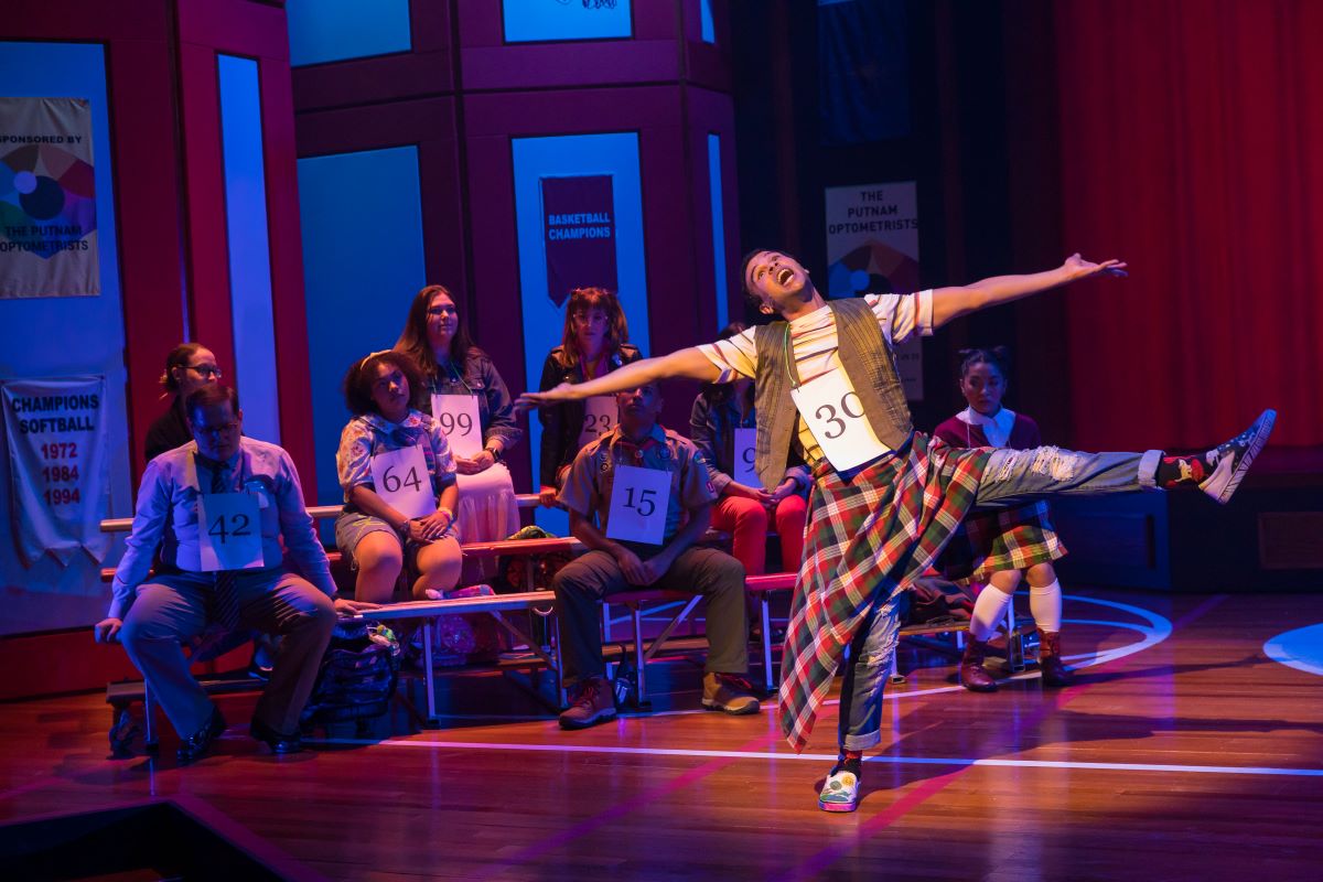 Leaf Coneybear (Dominique Lawson) alongside the cast and band of the IRT's 2024 production of The 25th Annual Putnam County Spelling Bee. (Photo/Zach Rosing)