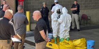 hazmat crew looks at package