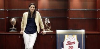Stephanie White posing with a no. 22 Indiana Fever jersey.