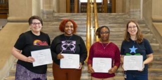 four people receiving library scholarships