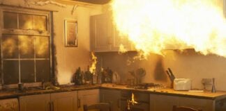 Fire raging in domestic kitchen at night