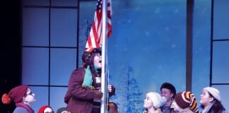 Flick (Alex Arickx) takes the “Triple Dog Dare” presented to him to stick his tongue on the school’s flagpole as the children watch in Beef & Boards Dinner Theatre’s production of A Christmas Story: The Musical, now on stage through Jan. 5.