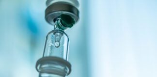 Close up medical intravenous IV drip in hospital background