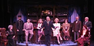 Detective Hercule Poirot (Andrew Kindig), center, reveals to the room of suspects who he believes killed Samuel Ratchett in Beef & Boards Dinner Theatre’s production of Murder on the Orient Express, now on stage. This mystery by Agatha Christie opens the 2025 Season at Beef & Boards, and is on stage through Feb. 9. For tickets and performance information, visit beefandboards.com.