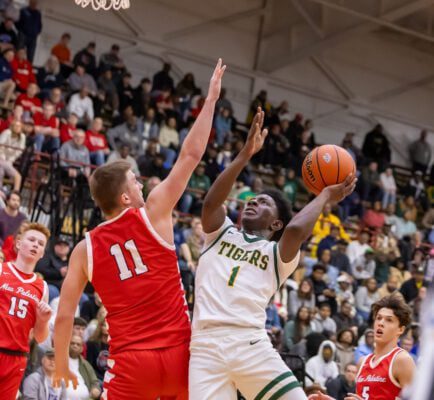 Crispus Attucks High School's Christion Hurt (1) New Palenstine High School's Julius Gizzi (11) on March 22, 2025 at Southport Fieldhouse in Southport, Indiana. (Photo/Walt Thomas)