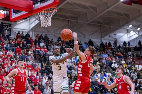 Crispus Attucks High School Ronsione Thomas (3) & New Palenstine High School's Austin McMahan (13) on March 22, 2025 at Southport Fieldhouse in Southport, Indiana. (Photo/Walt Thomas)
