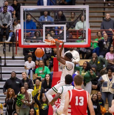 Crispus Attucks High School's Dezmon Briscoe (11) throws down a powerful dunks against New Palenstine High School on March 22, 2025 at Southport Fieldhouse in Southport, Indiana. (Photo/Walt Thomas)