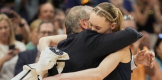 UConn guard Paige Bueckers (5) hugs UConn head coach Geno Auriemma as she comes off the floor late in the second half of the national championship game against South Carolina at the Final Four of the women's NCAA college basketball tournament, Sunday, April 6, 2025, in Tampa, Fla. (AP Photo/John Raoux)