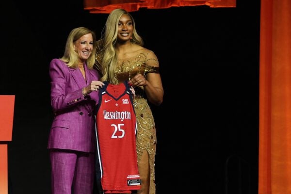 Kiki Iriafen and WNBA commissioner Cathy Engelbert during the 2025 WNBA Draft.