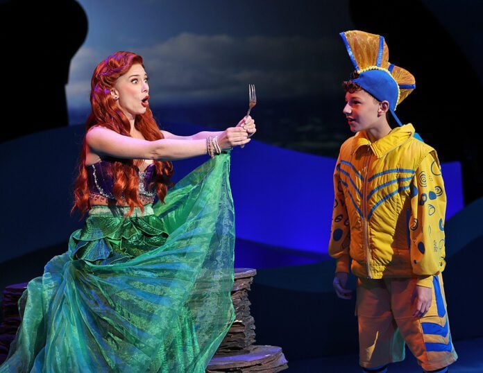 Ariel (Sarah Daniels) is delighted to discover a “dinglehopper” and shows it to Flounder (Asher Ortman) in Beef & Boards Dinner Theatre’s production of "Disney’s The Little Mermaid," now on stage through July 13. (Photo/Indy Ghost Light)