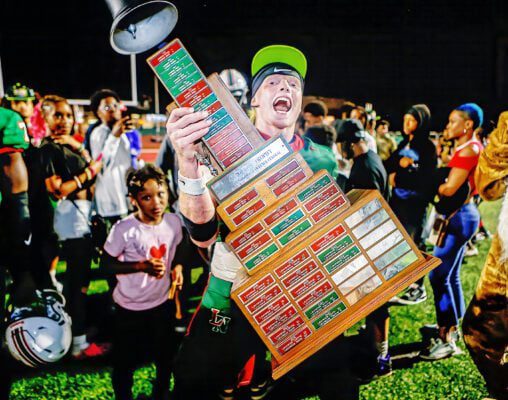 Breck Mallory lifts the trophy following the rivalry game between Lawrence North High School and Lawrence Central High School on Aug. 22, 2025. (Photo/David Dixon)