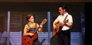 Elvis Presley (Nicholas Voss) watches his younger self (Henry Kirk) learn to play the guitar i n Beef & Boards Dinner Theatre's production of Heartbreak Hotel, now on stage through Oct. 12.