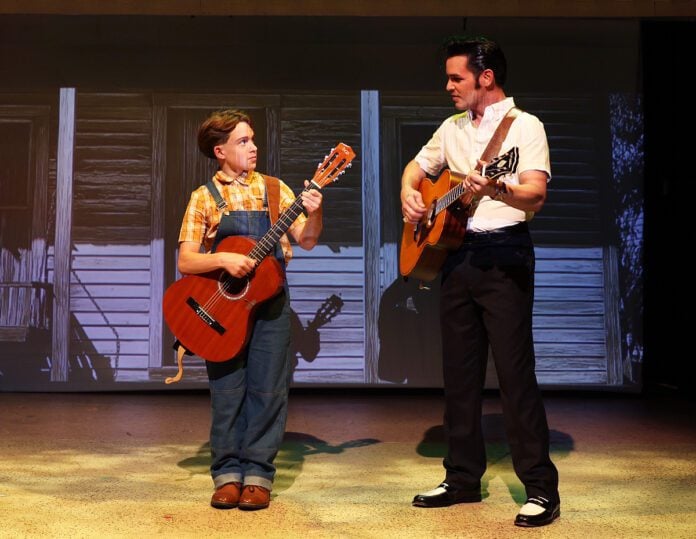 Elvis and Kid Elvis play guitar IMG_6164 Elvis Presley (Nicholas Voss) watches his younger self (Henry Kirk) learn to play the guitar i n Beef & Boards Dinner Theatre's production of Heartbreak Hotel, now on stage through Oct. 12.
