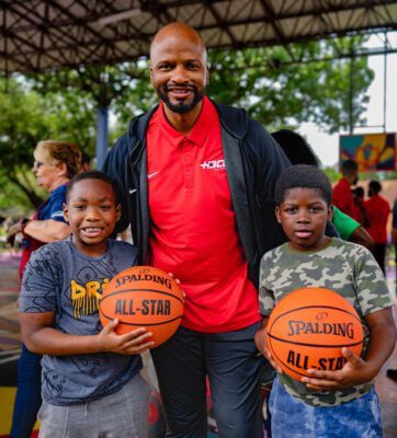 HBCU All-Star Game Travis Williams and members of the community holding pro-level basketballs in Houston, Texas.