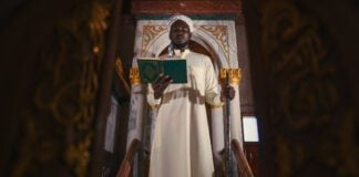 Democracy is ordained by Allah islam imam with koran book on hand making speech in isramic worship ceremony in mosque